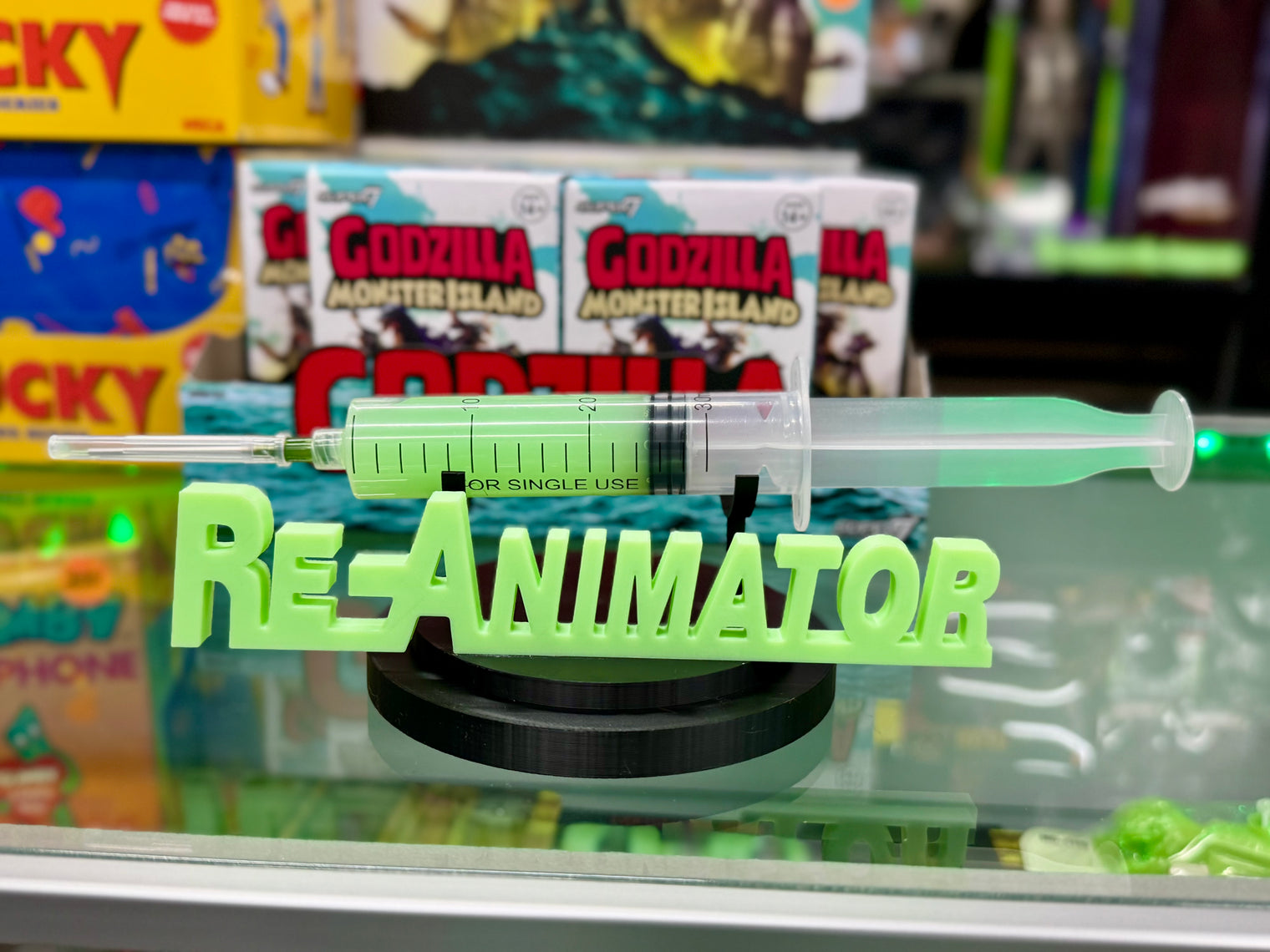 Re-Animator - UV Reactive Re-Agent with Glow in the Dark Logo Stand